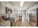 Modern kitchen featuring stainless steel appliances, white cabinetry, and wood floors at 8603 Ridgeline Ln, Charlotte, NC 28269