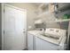 Laundry room with washer, dryer, wire shelving, and utility closet at 8603 Ridgeline Ln, Charlotte, NC 28269