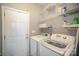 Laundry room with washer, dryer, wire shelving, and utility closet at 8603 Ridgeline Ln, Charlotte, NC 28269