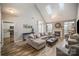 Spacious living room with vaulted ceiling, fireplace, skylights, and comfortable seating, creating an inviting atmosphere at 8603 Ridgeline Ln, Charlotte, NC 28269
