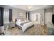Comfortable bedroom with a neutral walls, wood flooring, an ensuite bathroom, and lots of natural light at 8603 Ridgeline Ln, Charlotte, NC 28269