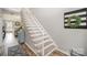Elegant staircase with carpeted steps and white railing, leading to the upper level of this inviting home at 8603 Ridgeline Ln, Charlotte, NC 28269