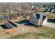 Aerial view of house with fenced backyard, solar panels, and mature trees at 8822 Crape Myrtle Dr, Stanfield, NC 28163