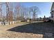 Fenced backyard with mature trees, play area and deck at 8822 Crape Myrtle Dr, Stanfield, NC 28163