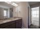 Bathroom features granite counters, dual sinks, framed mirrors and walk-in shower visible at 8822 Crape Myrtle Dr, Stanfield, NC 28163