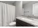 Bathroom with granite countertop vanity, white toilet, and shower curtain at 8822 Crape Myrtle Dr, Stanfield, NC 28163