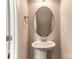 Half bath featuring pedestal sink, oval mirror and neutral wall color at 8822 Crape Myrtle Dr, Stanfield, NC 28163