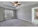 Bright bedroom with carpet, tray ceiling, ceiling fan and large window overlooking natural setting at 8822 Crape Myrtle Dr, Stanfield, NC 28163
