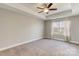 Bright bedroom with carpet, tray ceiling, ceiling fan and large window overlooking natural setting at 8822 Crape Myrtle Dr, Stanfield, NC 28163