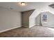 Spacious carpeted bedroom with dormer and window letting in natural light at 8822 Crape Myrtle Dr, Stanfield, NC 28163