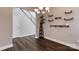 Dining room with dark floors, modern light fixture, display shelving, and staircase access at 8822 Crape Myrtle Dr, Stanfield, NC 28163