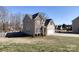 Inviting two-story home with brick and siding details, a backyard, and an attached two-car garage at 8822 Crape Myrtle Dr, Stanfield, NC 28163
