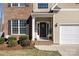 Cozy front porch with decorative wreath, charming details, and an attached two-car garage at 8822 Crape Myrtle Dr, Stanfield, NC 28163