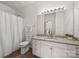 Well-lit bathroom showcasing a granite countertop, modern fixtures, and a shower with curtain at 8830 Cinnabay Dr, Charlotte, NC 28216