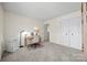 Bedroom featuring neutral carpet, a desk, and a closet with double doors at 8830 Cinnabay Dr, Charlotte, NC 28216