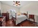 Cozy bedroom boasts hardwood floors, a classic ceiling fan, and ample natural light at 8830 Cinnabay Dr, Charlotte, NC 28216