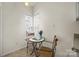Cozy breakfast nook with a small table, two chairs, and natural light from the window at 8830 Cinnabay Dr, Charlotte, NC 28216