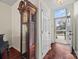 Inviting foyer with hardwood floors, a grandfather clock, and a view of the front door and outside at 8830 Cinnabay Dr, Charlotte, NC 28216
