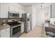 Modern kitchen with stainless steel appliances, white cabinets, and ample counter space at 8830 Cinnabay Dr, Charlotte, NC 28216