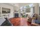 Bright living room with fireplace, hardwood floors, and sliding doors to outdoor patio at 8830 Cinnabay Dr, Charlotte, NC 28216