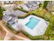 Aerial view of the community pool with a cabana and surrounded by lush greenery at 8830 Cinnabay Dr, Charlotte, NC 28216