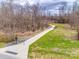 Scenic walking path surrounded by lush greenery and trees, perfect for outdoor recreation at 8830 Cinnabay Dr, Charlotte, NC 28216