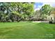 Well-maintained backyard featuring a large grassy area and outdoor patio at 908 Dogwood Dr, Gastonia, NC 28054