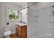 Bathroom featuring a shower and a single sink vanity with granite countertop at 908 Dogwood Dr, Gastonia, NC 28054