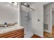 Bathroom featuring a wooden vanity, granite countertop, and a shower with modern fixtures at 908 Dogwood Dr, Gastonia, NC 28054