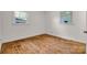 Bedroom featuring hardwood floors, a neutral paint and two windows providing ample natural light at 908 Dogwood Dr, Gastonia, NC 28054
