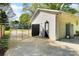 Exterior view of the garage, featuring a side door, fenced enclosure, and an automatic door at 908 Dogwood Dr, Gastonia, NC 28054
