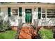 Welcoming front entrance with a vibrant green door, brick steps and matching shutters at 908 Dogwood Dr, Gastonia, NC 28054