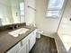 Well-lit bathroom features modern vanity, tiled shower, and neutral color palette at 9513 Isaac Hunter Dr, Charlotte, NC 28214