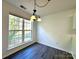 Bright dining area with a charming chandelier and large windows overlooking the landscaped yard at 9513 Isaac Hunter Dr, Charlotte, NC 28214
