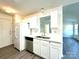 Bright kitchen featuring white cabinets, stainless steel sink, and modern appliances at 9513 Isaac Hunter Dr, Charlotte, NC 28214