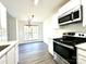 Contemporary kitchen with stainless appliances and eat-in dining area with view to the backyard at 9513 Isaac Hunter Dr, Charlotte, NC 28214