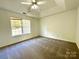 Serene main bedroom with a trey ceiling, fan, and a large window offering great natural light at 9513 Isaac Hunter Dr, Charlotte, NC 28214