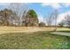 Spacious backyard with ample green space and mature trees with concrete area at 9900 Meadowmead Ct, Charlotte, NC 28273