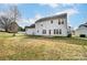 Backyard view showcasing the lawn, mature trees, and the back of the house at 9900 Meadowmead Ct, Charlotte, NC 28273