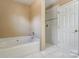 Bathroom featuring a garden tub and a tiled shower with white tile flooring at 9900 Meadowmead Ct, Charlotte, NC 28273