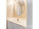 Well-lit bathroom with white cabinets, an oval mirror, and a sink at 9900 Meadowmead Ct, Charlotte, NC 28273