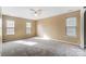 Spacious bedroom featuring neutral walls, carpet, and plenty of natural light at 9900 Meadowmead Ct, Charlotte, NC 28273