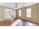 Bright dining room with hardwood floors and elegant chandelier, bathed in natural light at 9900 Meadowmead Ct, Charlotte, NC 28273