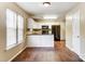 Stylish kitchen with white cabinets, black appliances, and hardwood floors at 9900 Meadowmead Ct, Charlotte, NC 28273