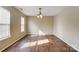 Neutral living room with wood floors, chandelier, and natural light, offering versatile design at 9900 Meadowmead Ct, Charlotte, NC 28273