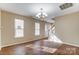 Bright living room with hardwood floors and a chandelier, ideal for entertaining guests at 9900 Meadowmead Ct, Charlotte, NC 28273