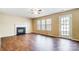 Cozy living room features a fireplace, hardwood floors, and large windows at 9900 Meadowmead Ct, Charlotte, NC 28273