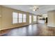Open-concept living area with wood floors, fireplace, and seamless flow to kitchen at 9900 Meadowmead Ct, Charlotte, NC 28273
