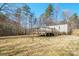 This is a wide shot of the home, including the deck with access to the grassy backyard at 1049 Ramsey St, Stanley, NC 28164