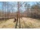 Expansive backyard featuring mature trees, and dog house, providing a secluded and private oasis at 1049 Ramsey St, Stanley, NC 28164